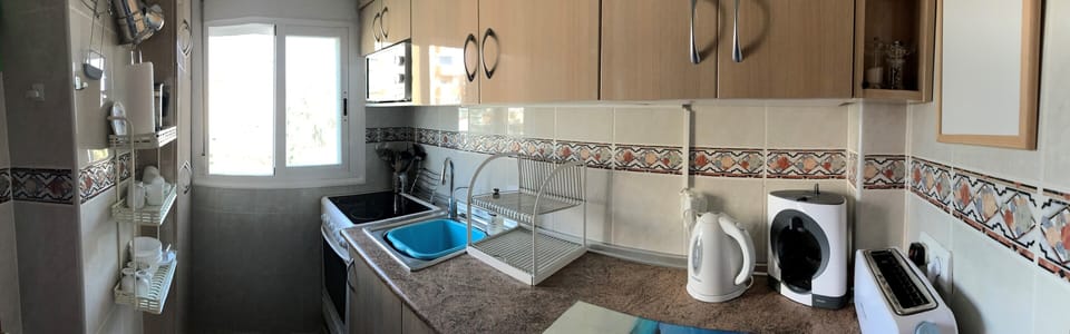 Panoramic view of kitchen with views to gardens and pool