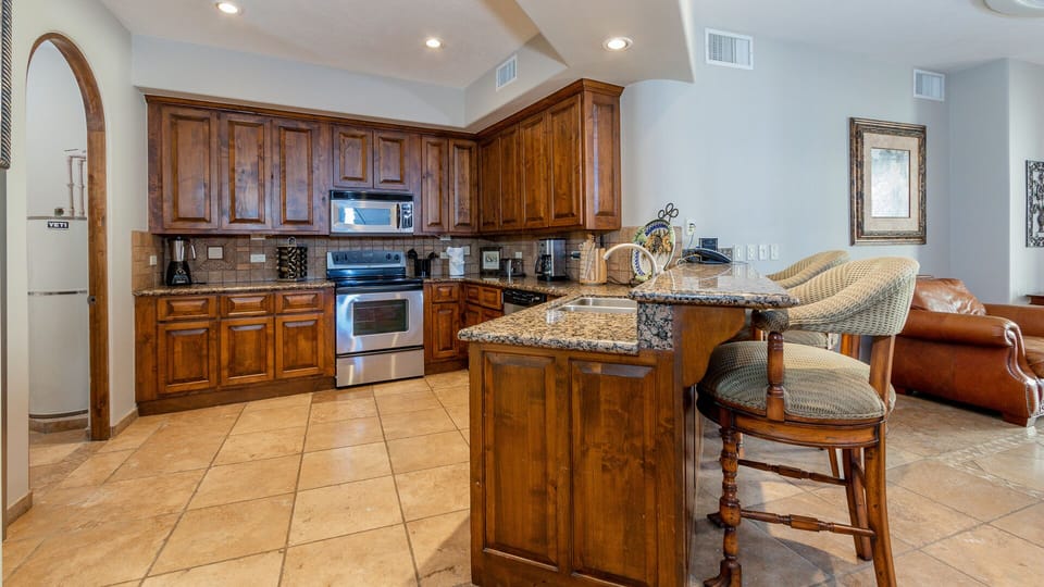 Well-stocked kitchen with stainless appliances.