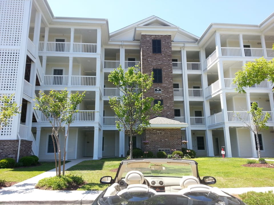 Building front.  Condo is at the end of the sidewalk