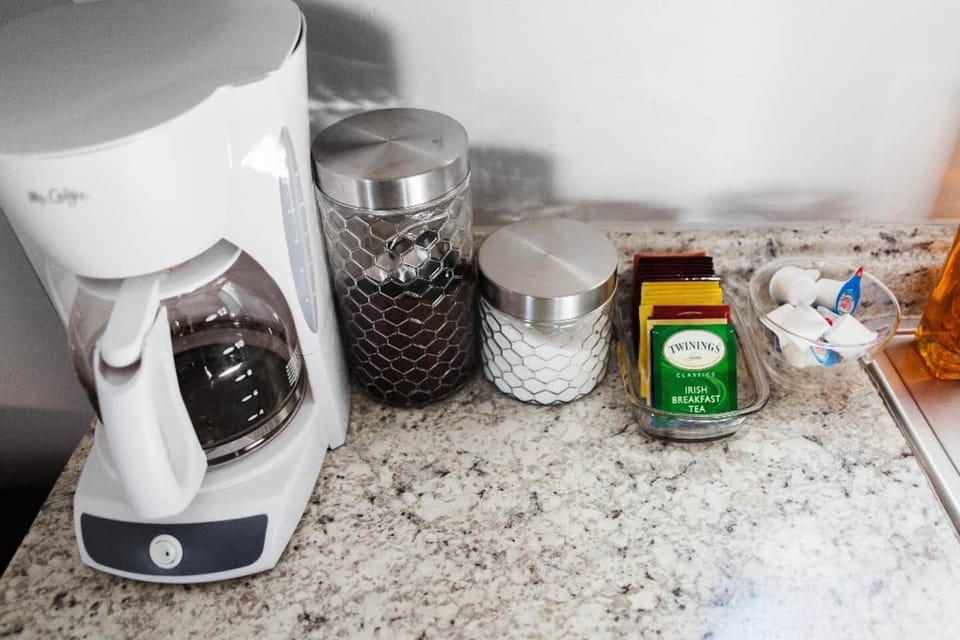 Mr Coffee pot with Folgers coffee, sugar, and creamer are always provided.