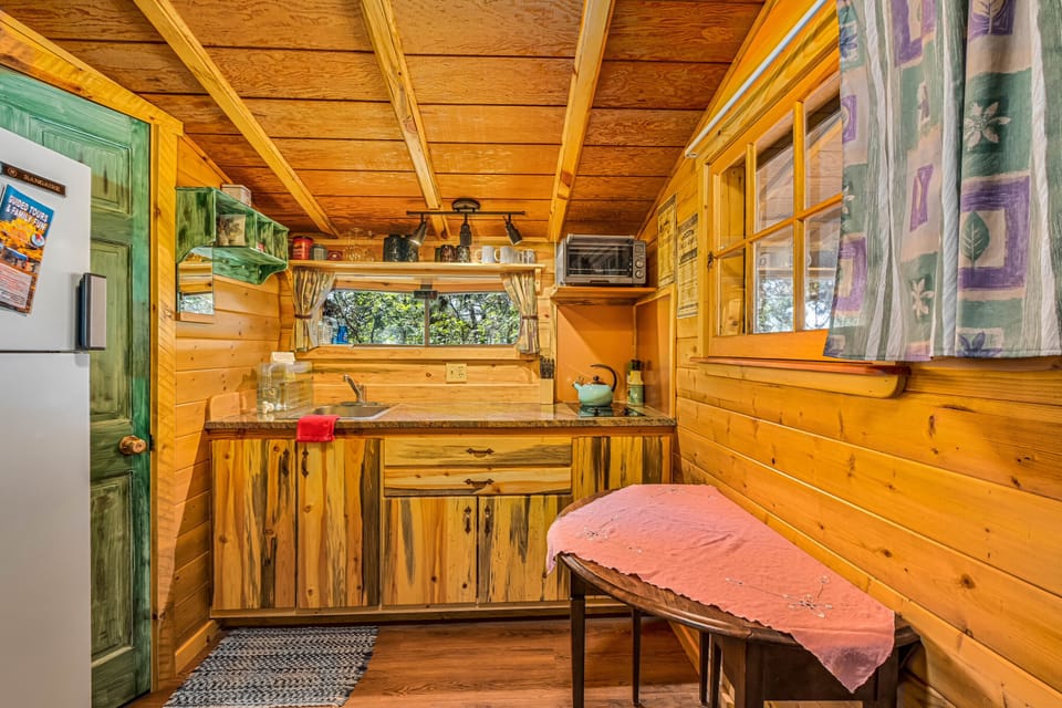 Kitchen fully stocked with cookware, dishes, coffee maker, and more