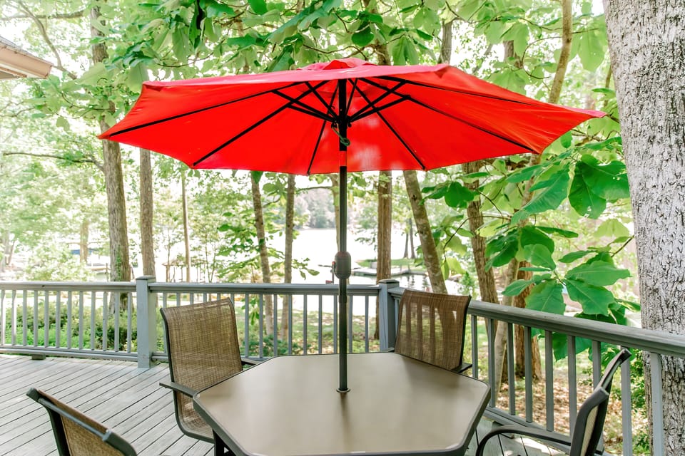 porch table with umbrella is perfect for dinners outside looking over the lake.