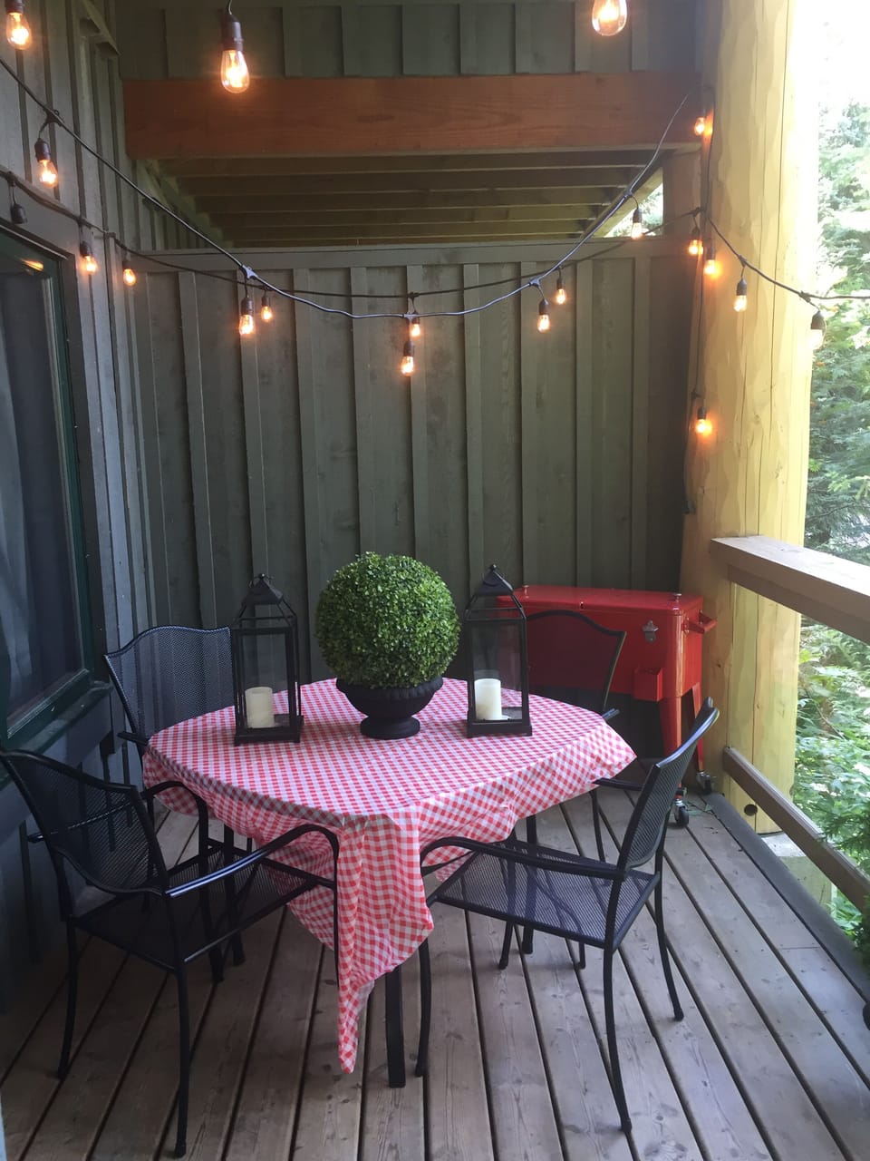 Private deck with BBQ and vintage string lighting