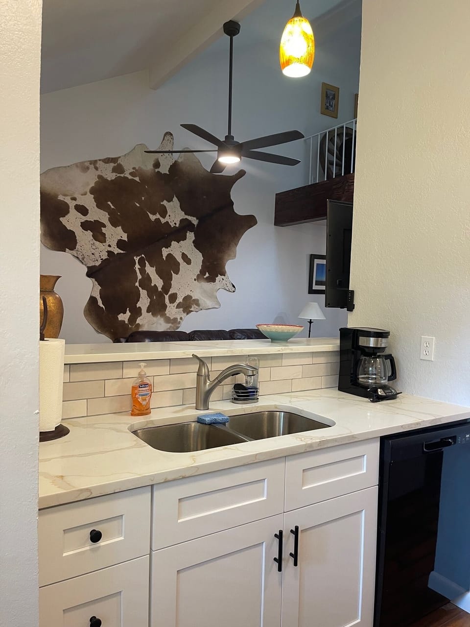 Opened up the space between the kitchen and living room. Added a big ceiling fan