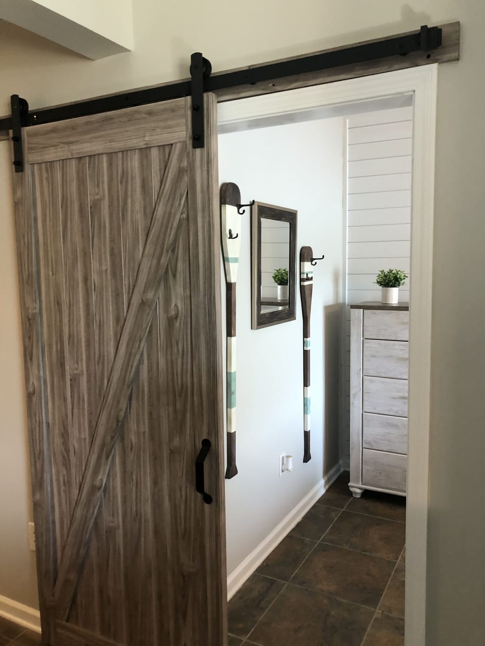 King bedroom behind barn door 
