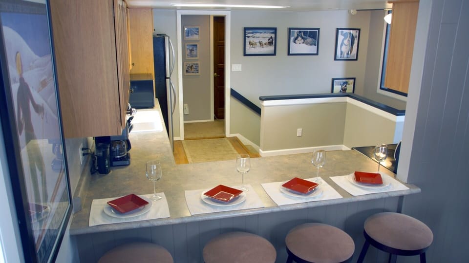 kitchen bar seating for 4 between the kitchen and 8 person dining room table.  