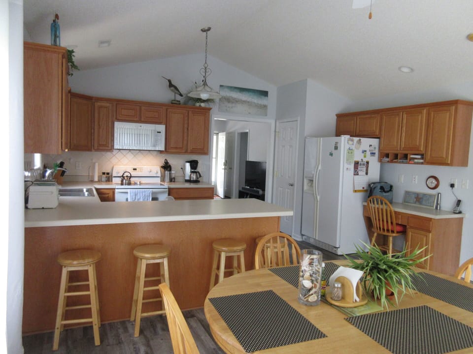 View from dining area into living room and towards front door
