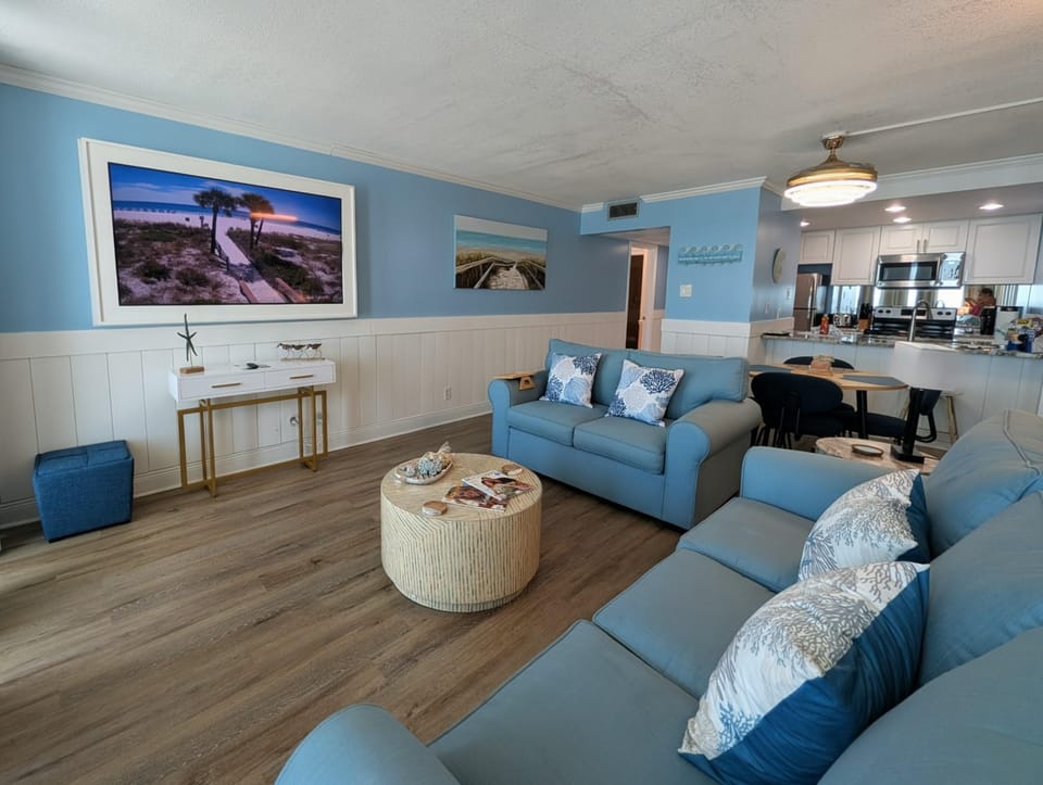 Spacious living room with cozy seating and vibrant art