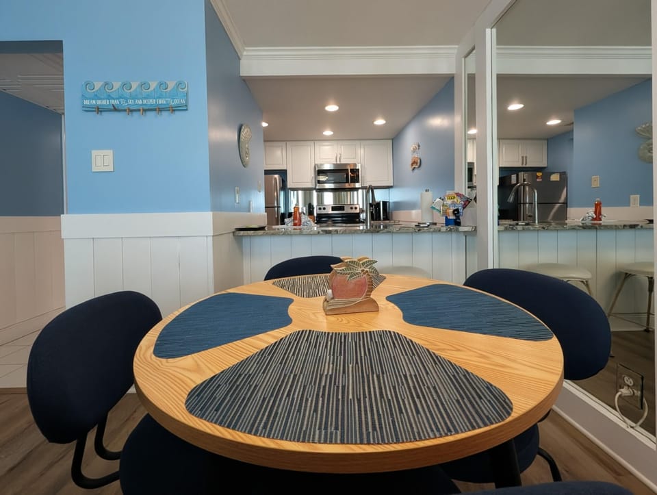 Cozy dining nook with vibrant blue accents and open layout