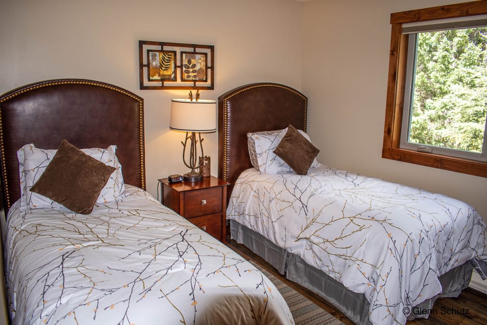 Third bedroom is on main level with two twin beds and luggage racks and closet.