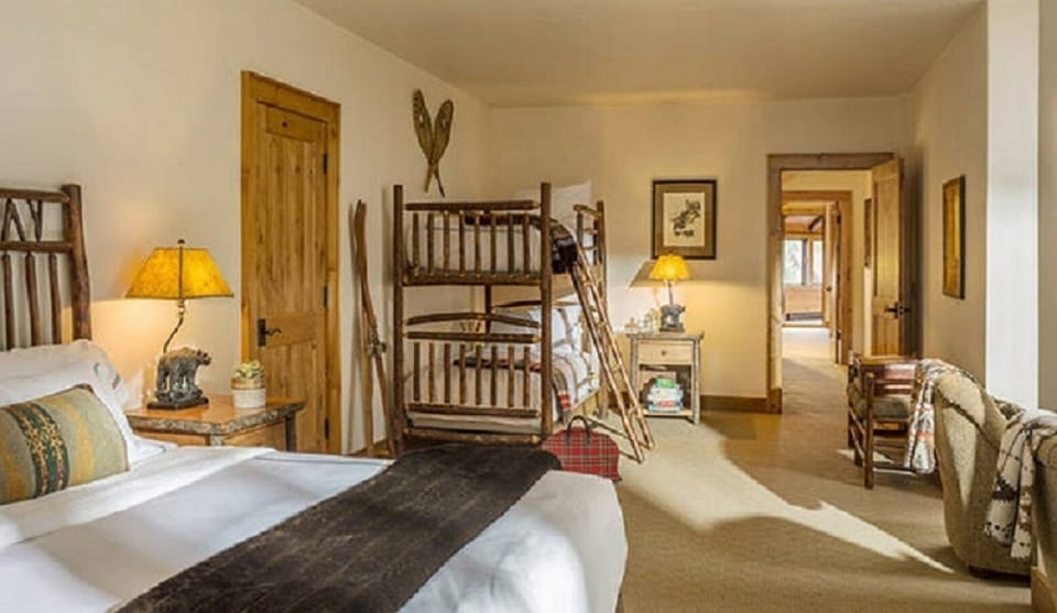 Second bedroom upstairs offers a single twin, queen bed with twin bunk on top