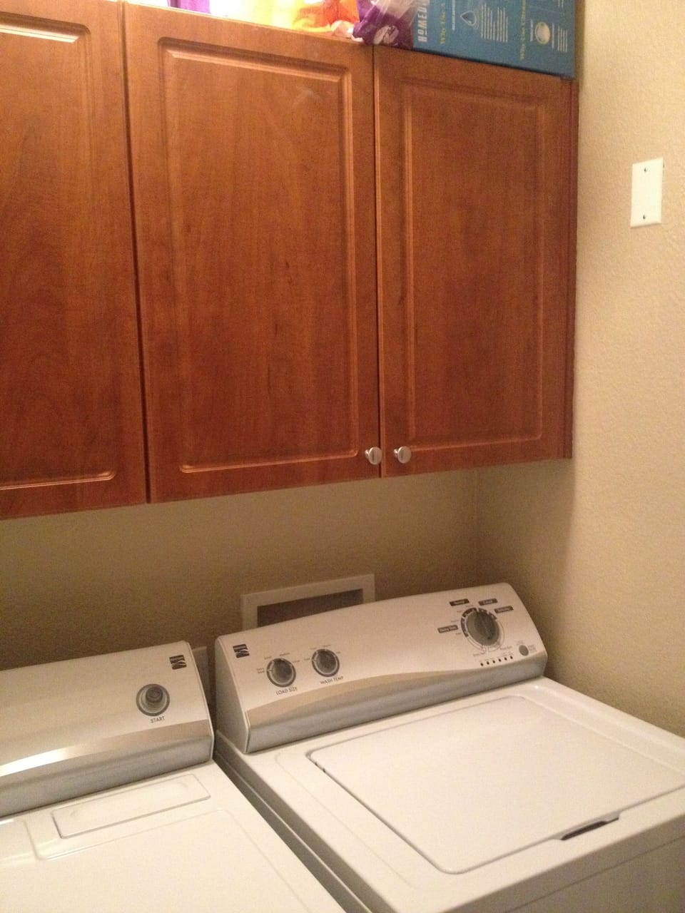 Full-sized washer and dryer reside behind closet doors at the back entry.