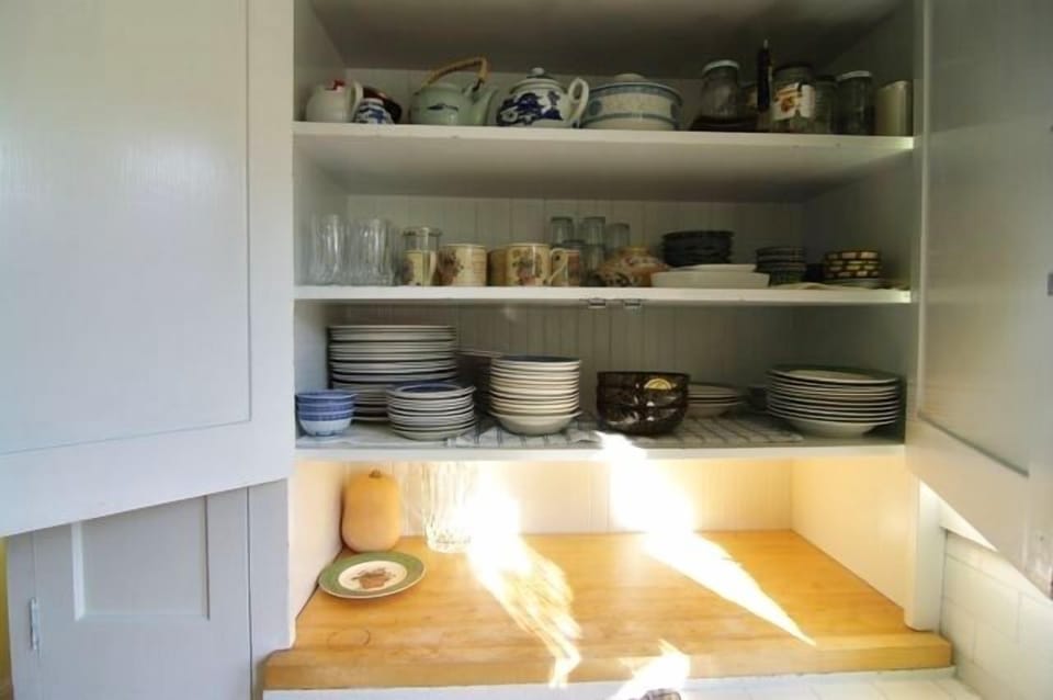 one of the kitchen cupboard. Dishes are Wedgwood