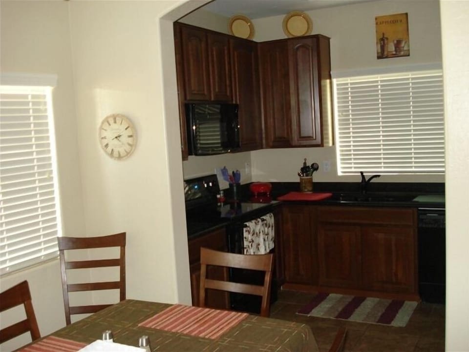 Complete Kitchen and Dining Area with Views to the Patio and Adjacent Park.