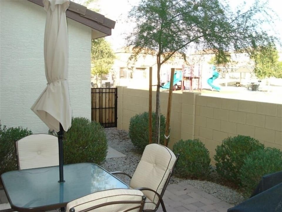 Patio with Gas BBQ, Table and Chairs and Views to the Park, Pool and Play Area.