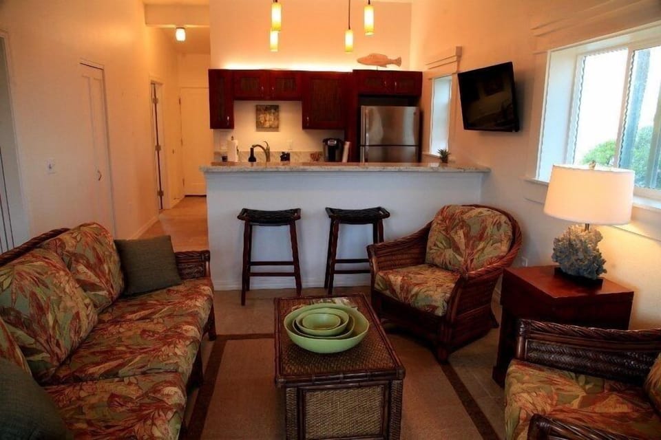 The living area looking at the kitchen bar. Note the two ocean view windows.