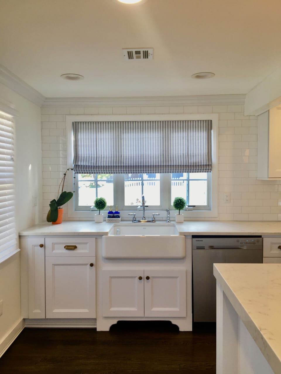 Kitchen sink looking out to beach entrance & dishwasher.
