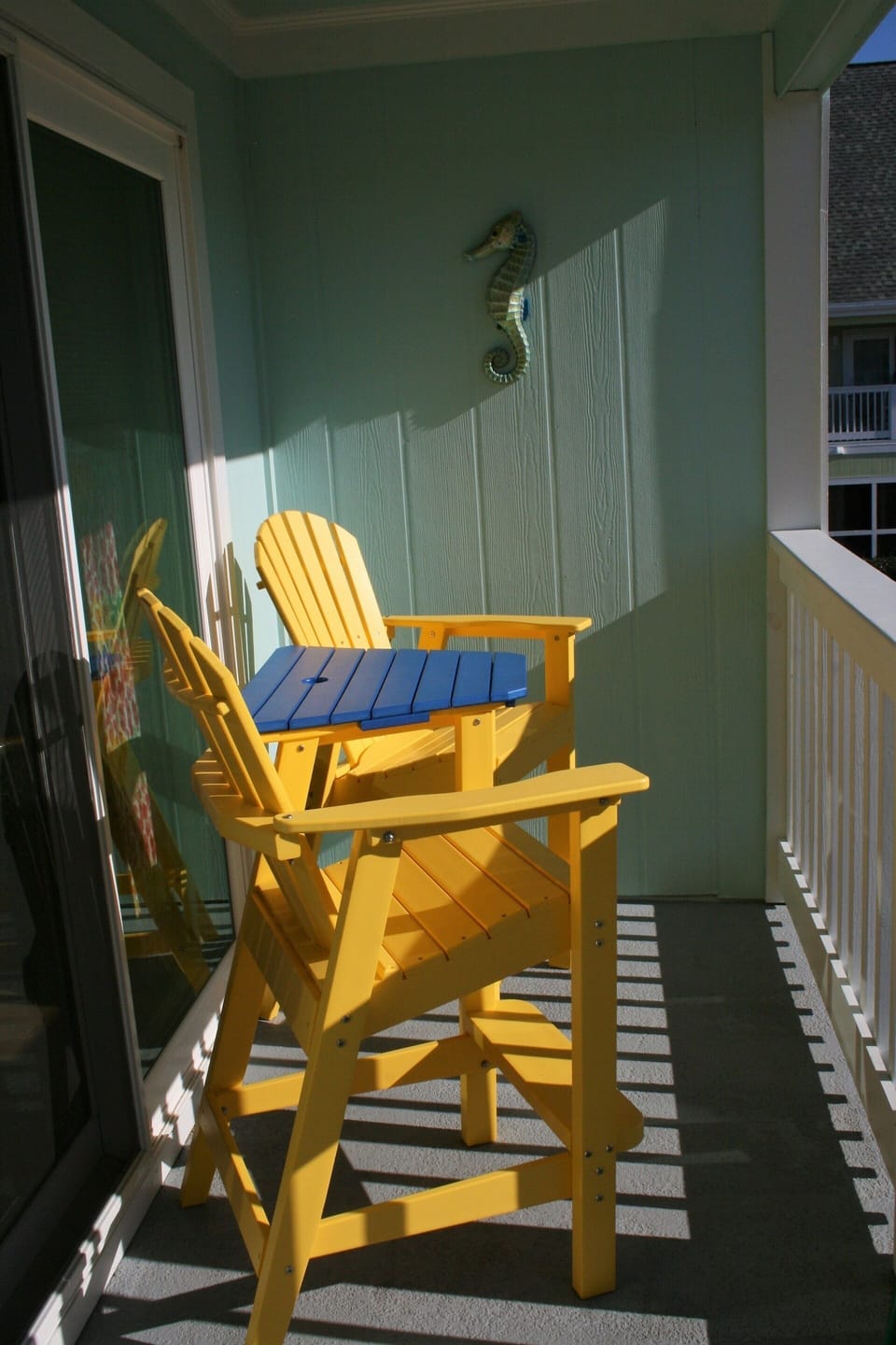 Colorful patio chairs catch the morning sun. Great spot for breakfast.
