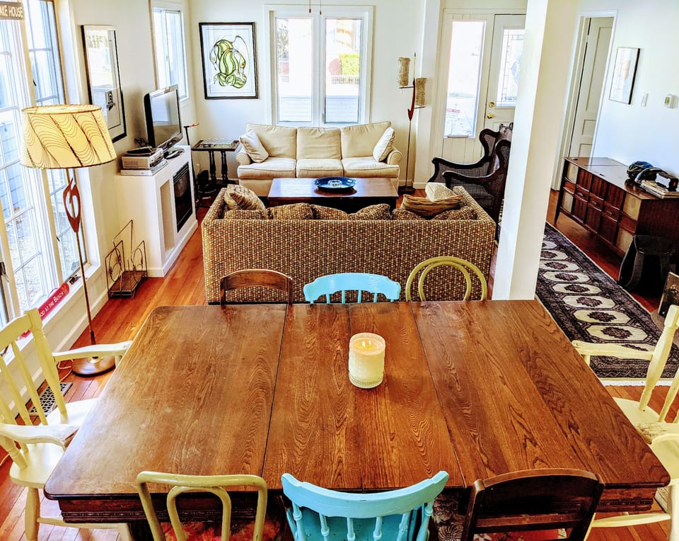 Freshly painted open concept dining/living room with seating for up to 8 people