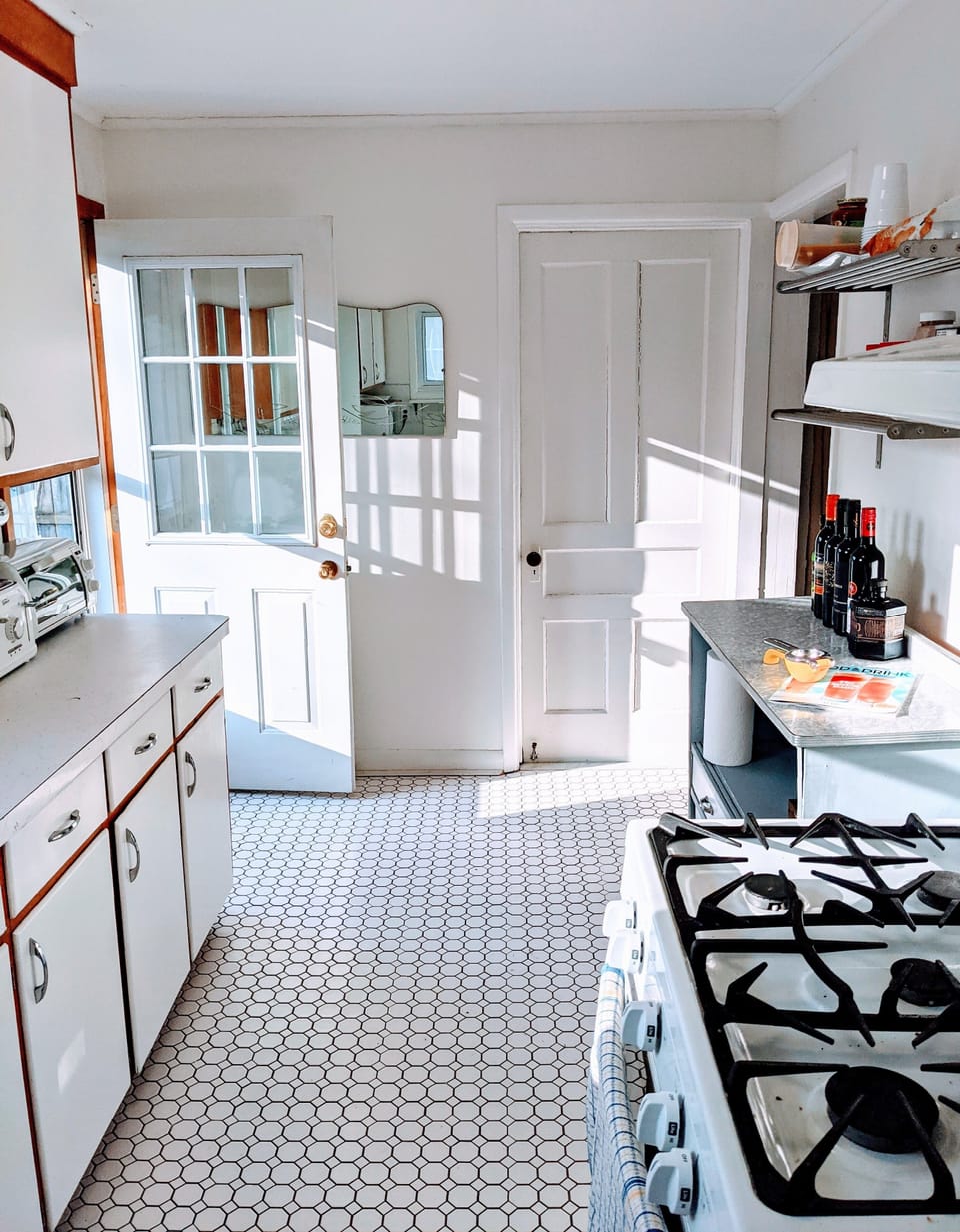 Kitchen with afternoon sun. Access to backyard patio and BBQ area.