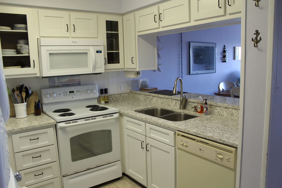 Fully equipped and updated kitchen. Full size fridge and washer/dryer to left.
