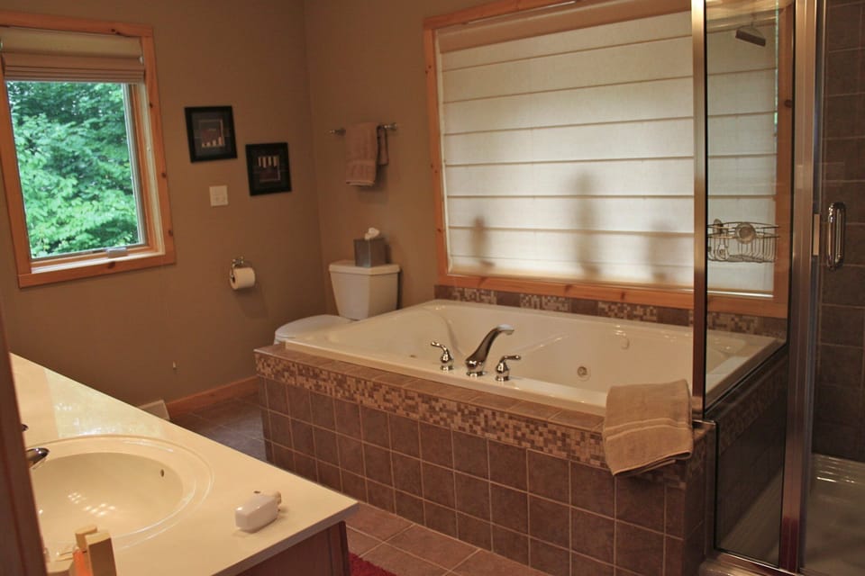 Master bath includes a jetted tub and rain shower