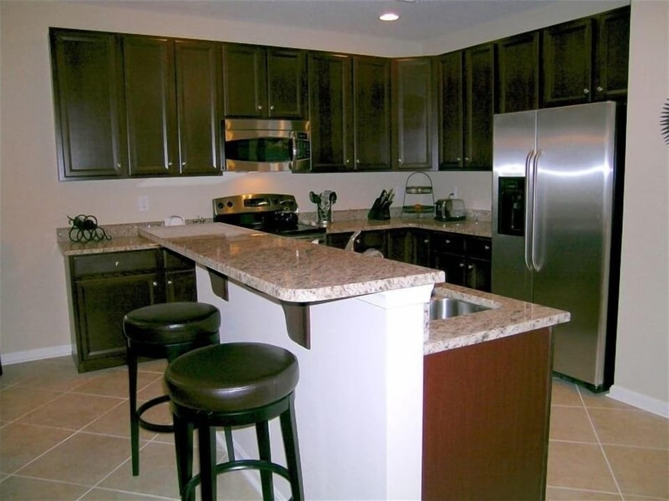 Kitchen w/granite counterops, stainless steel appliances and recessed lighting