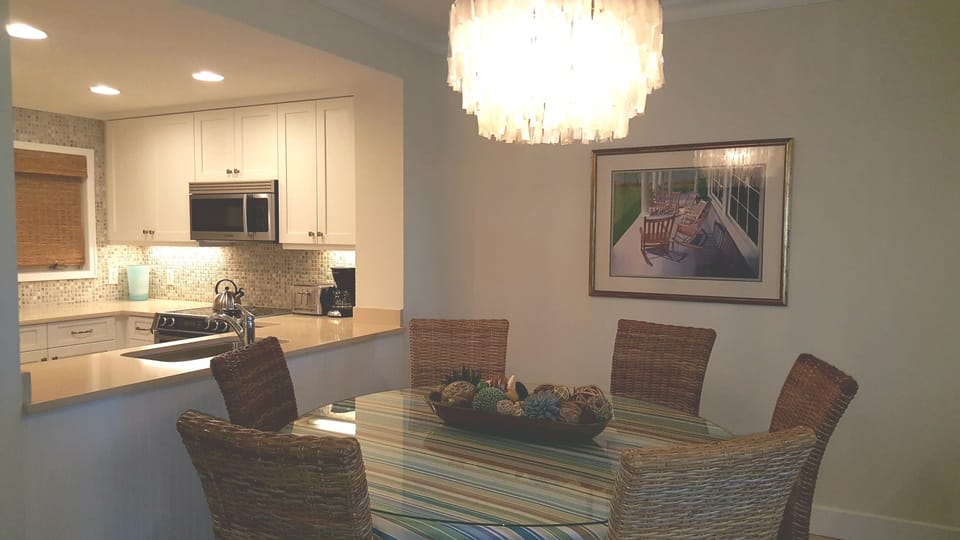 Comfortable dining area convenient to well-equipped modern kitchen