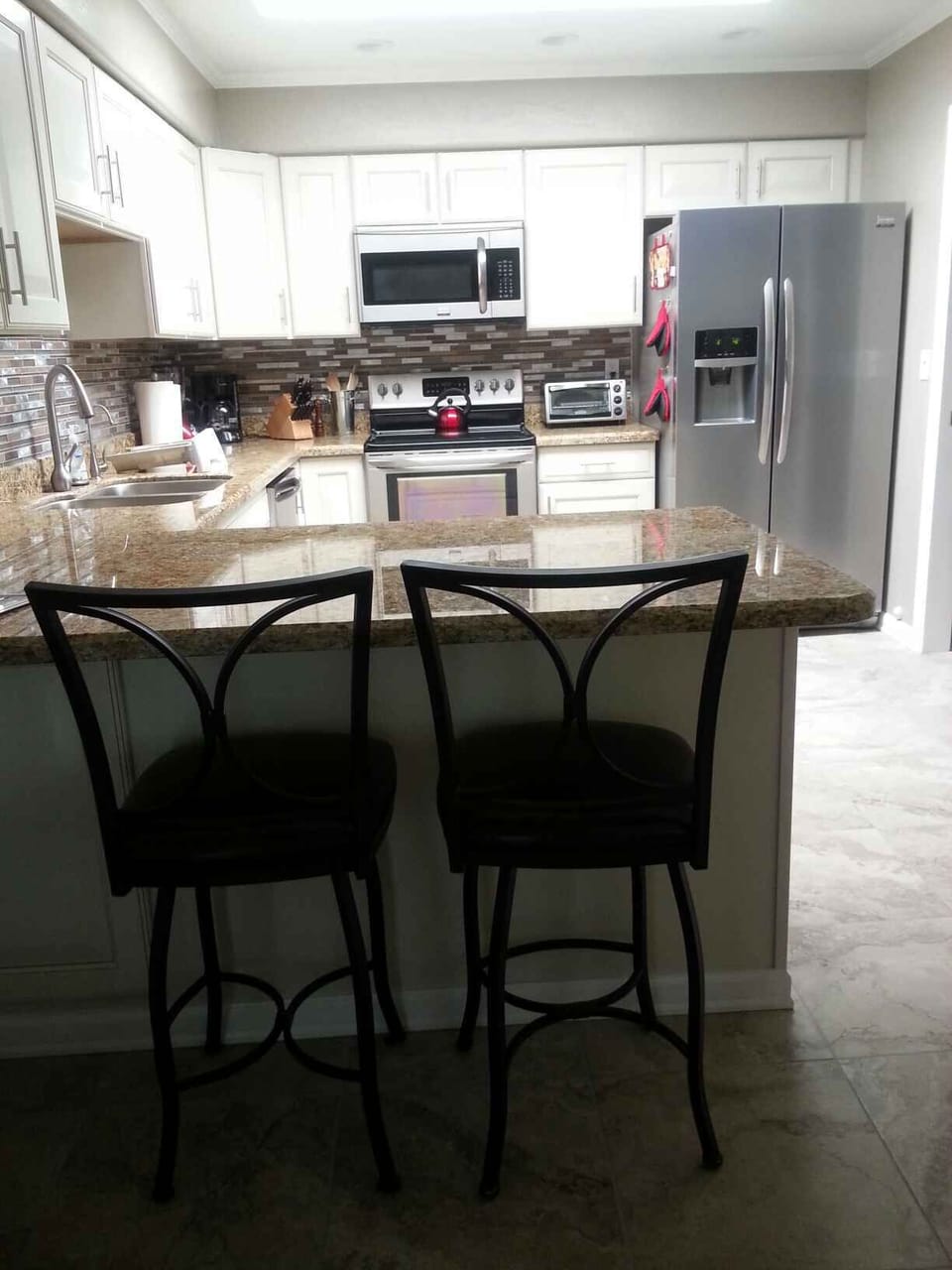 Bar area in large open kitchen to the right Parson table and chairs
