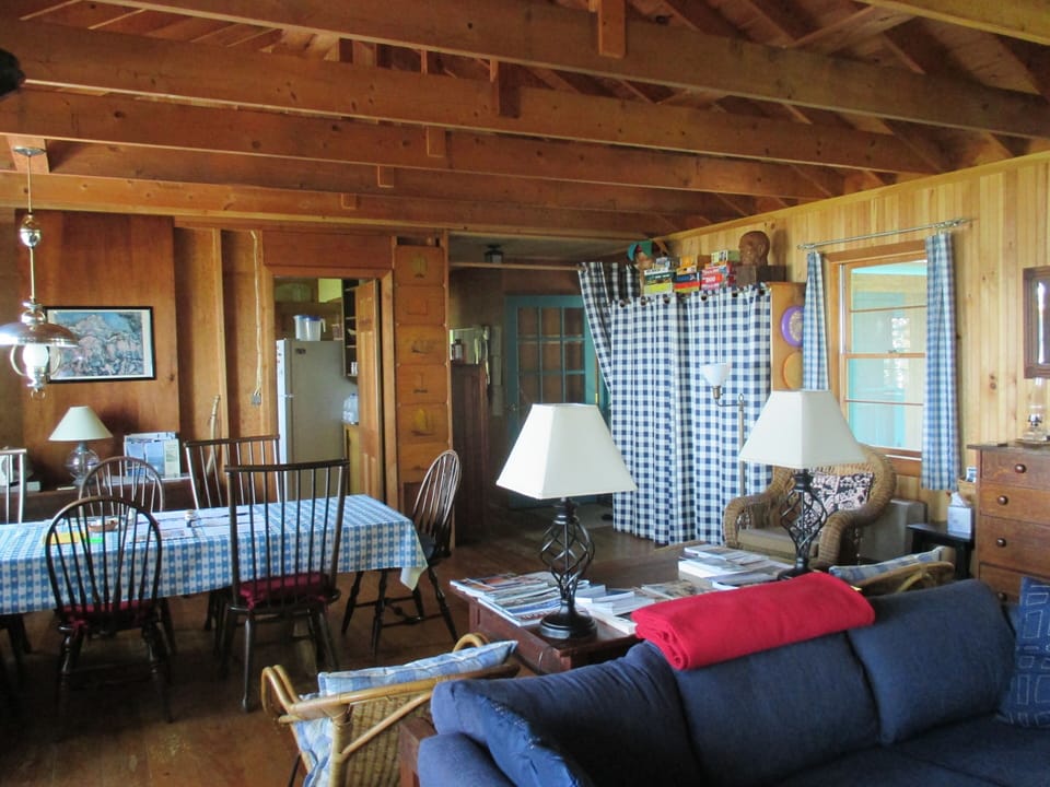 Dining area with kitchen behind, front entrance on right