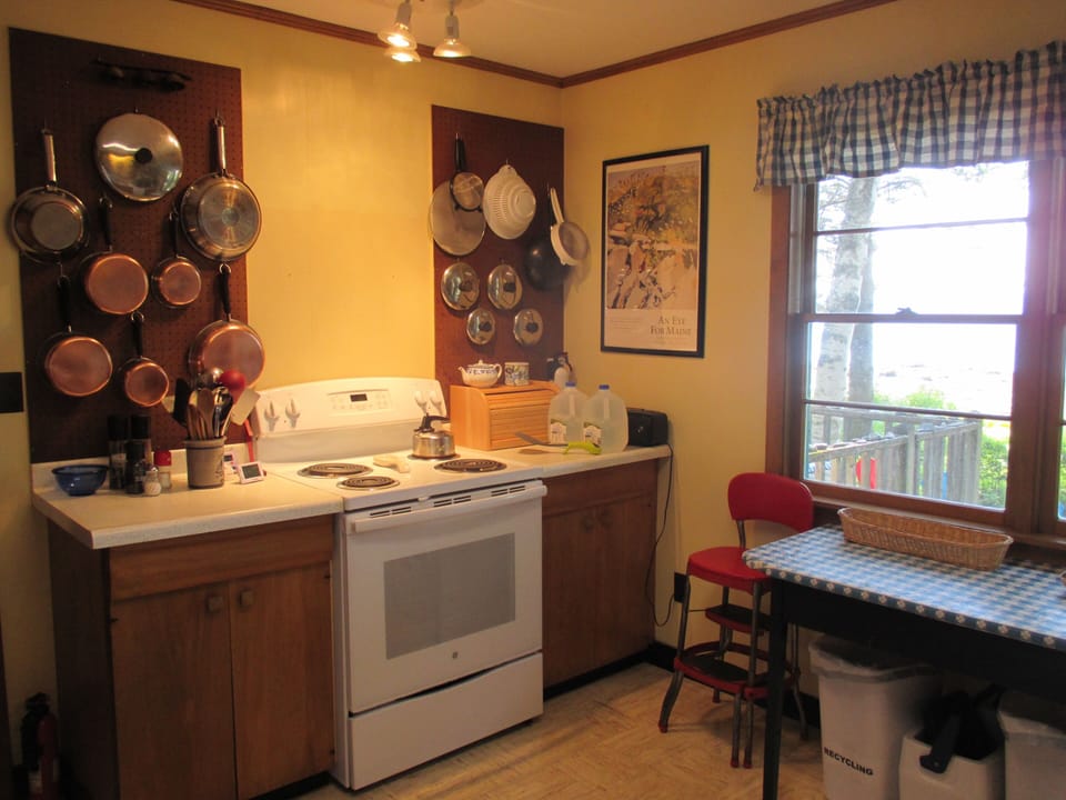 Old-fashioned high chair by window looking towards Penobscot Bay
