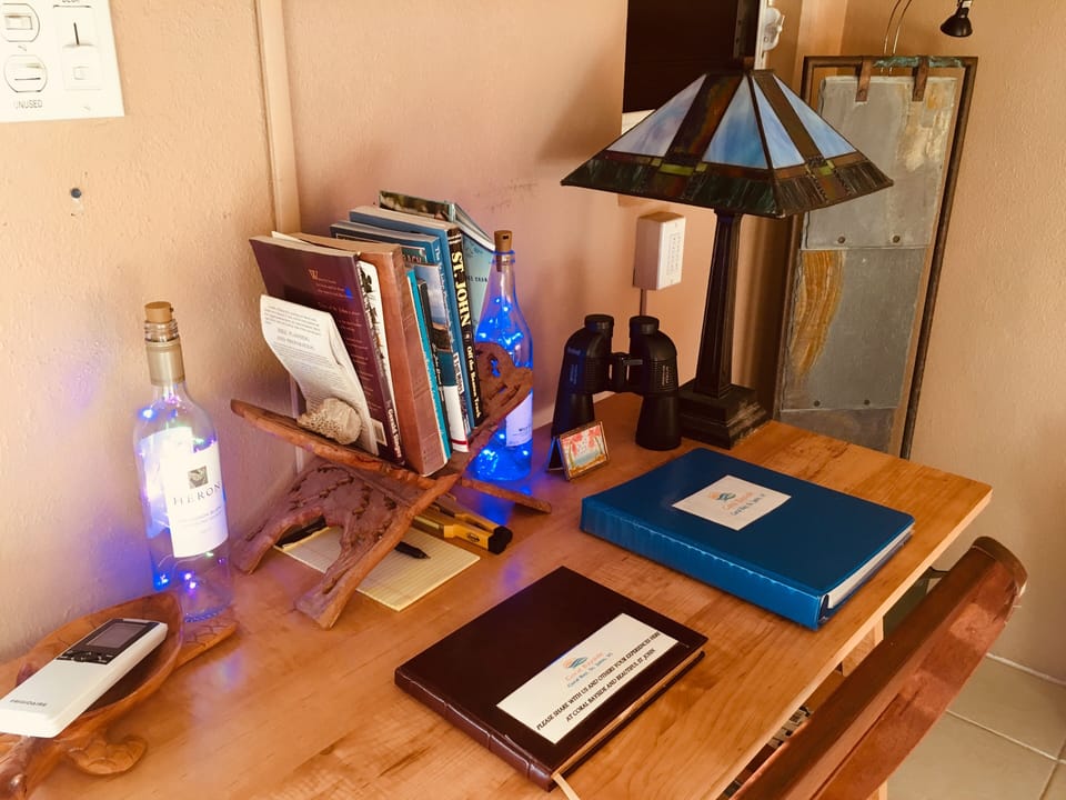 Desk With Guide Books And Info Binder. Slate Waterfall In Background.