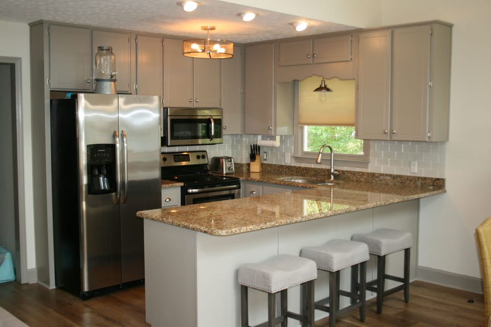 Updated kitchen with granite countertops and stainless steel appliances