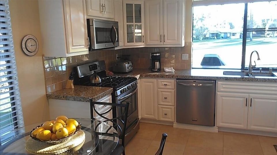 Granite countertops & stainless steel Appliances.  Window faces the golf course