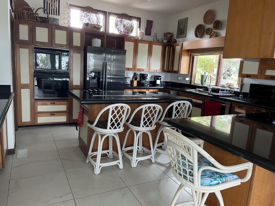 Kitchen has counter seating for 7.
Well stocked for cooking, utensils, dishes 