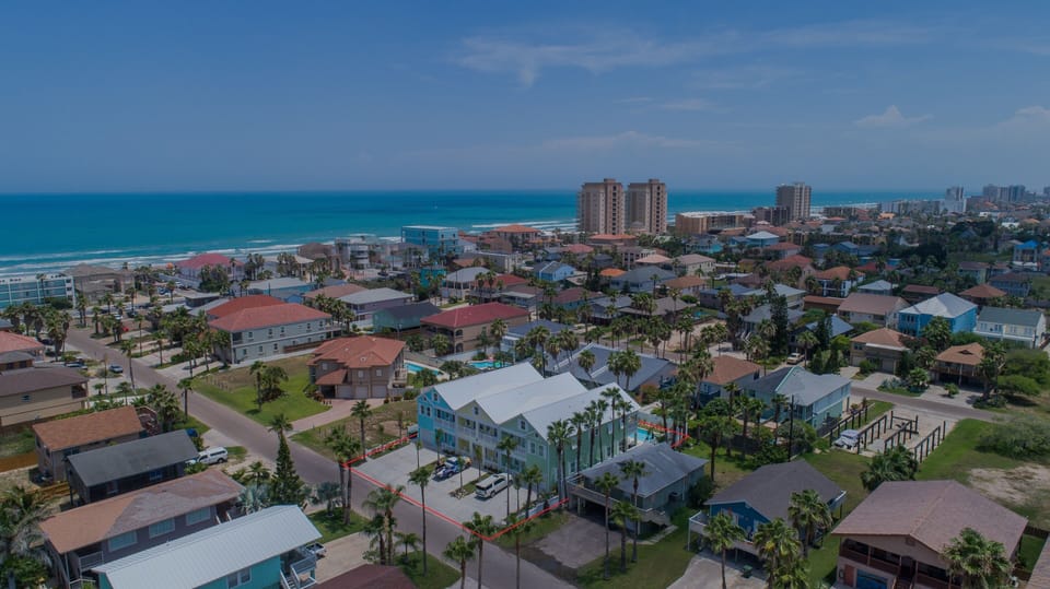 Aerial view showcasing the spacious vacation home just half a block from the beach.
