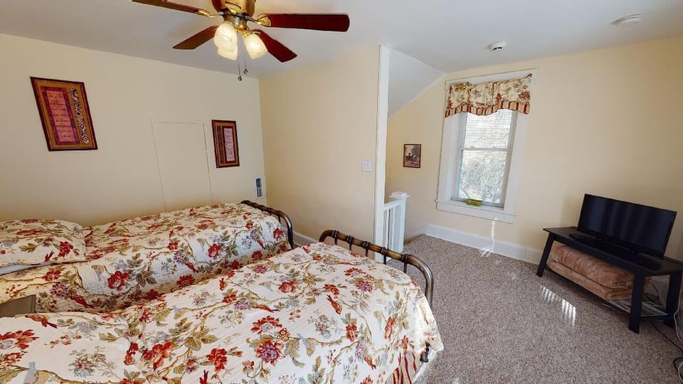 Bedroom 2. Twin sized beds, flat screen TV, fan, extra blankets. 