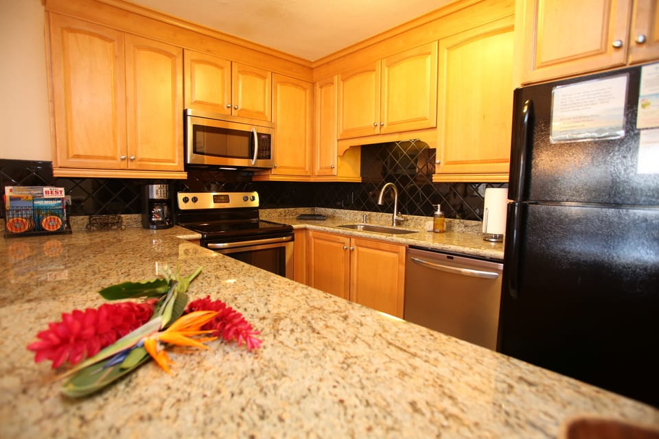 New granite countertops and upgraded cabinetry in the kitchen.