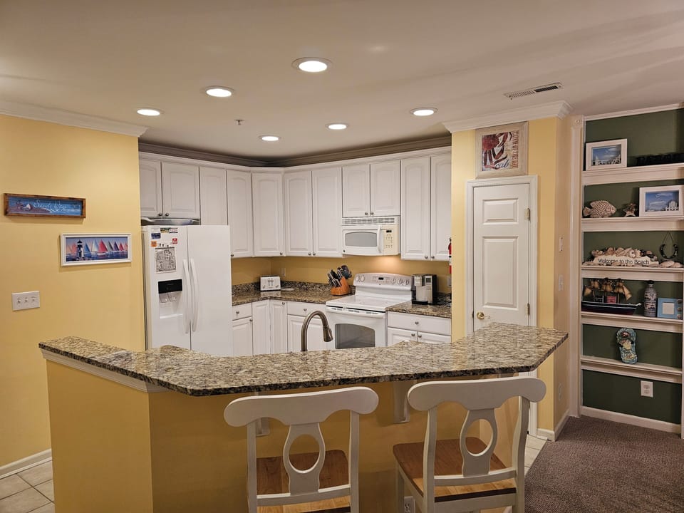Well maintained kitchen with two seats at island