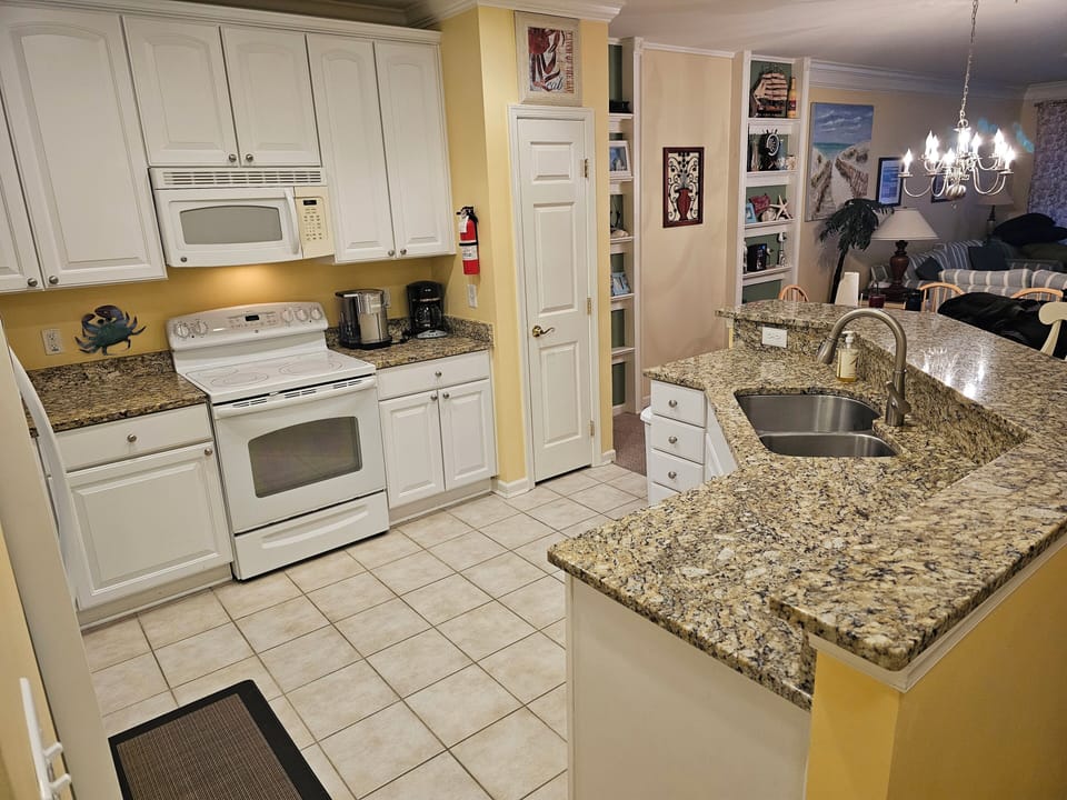 Kitchen features granite counter tops with double kitchen sink