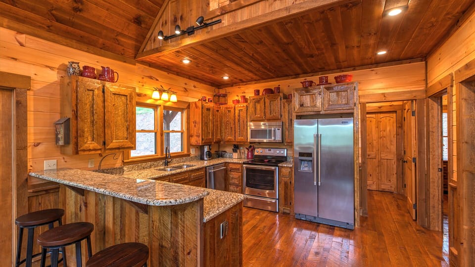 Fully Equipped Gourmet Kitchen featuring Stainless Steel Appliances and Breakfast Bar With Seating for 3