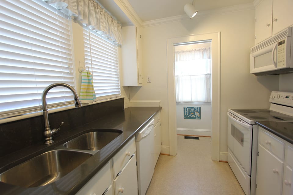 Efficient galley kitchen with view into the pantry.