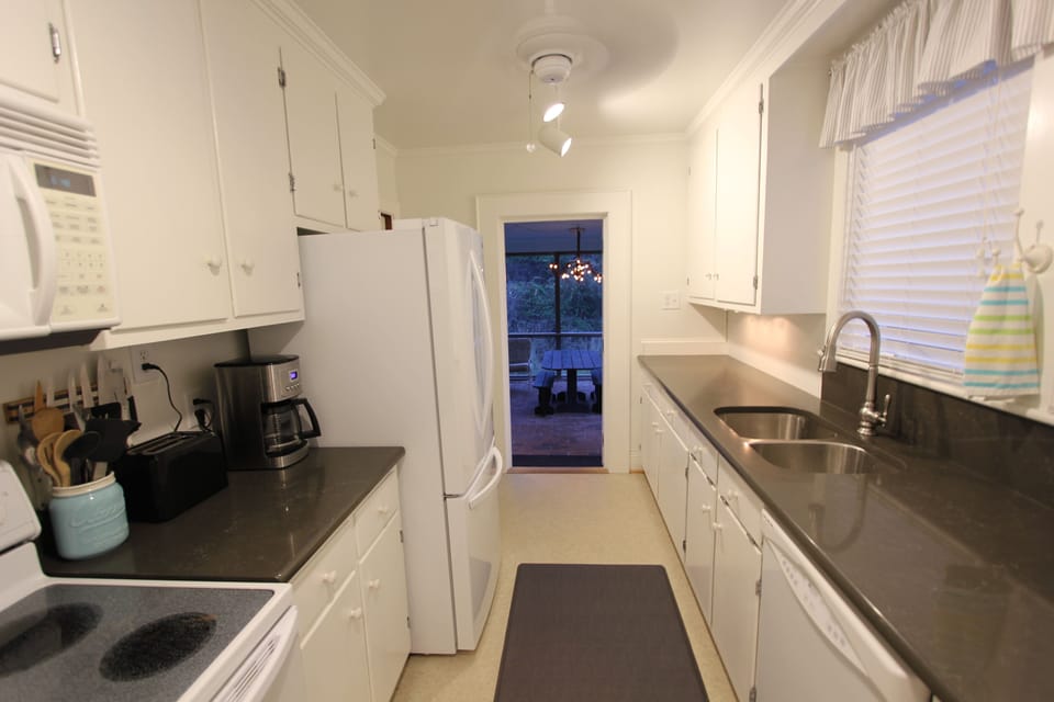 Clean, bright, & newly renovated kitchen with direct access to our screen porch