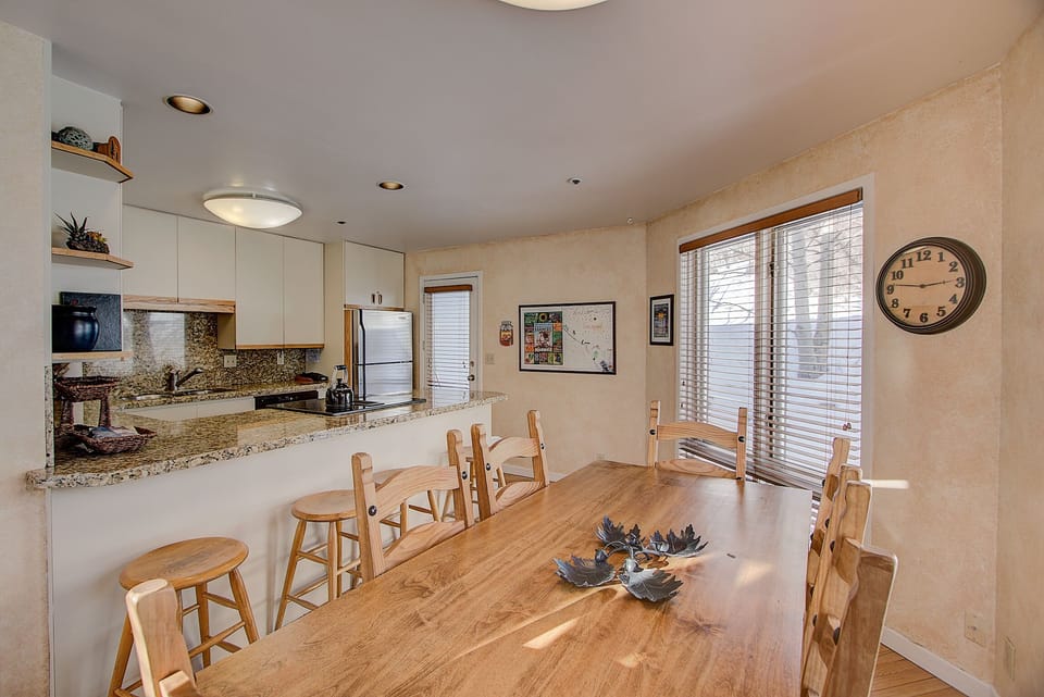Dining room looking at kitchen. Door to a covered porch w a gas grill steps away