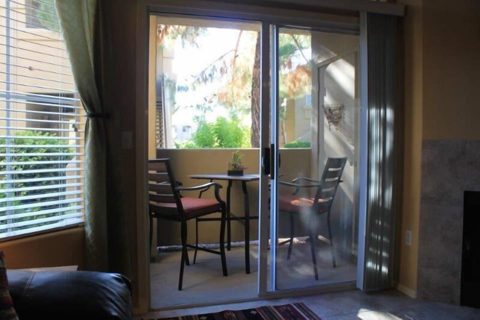 Bright west facing patio with bar height table and chairs. Looks onto greenspace