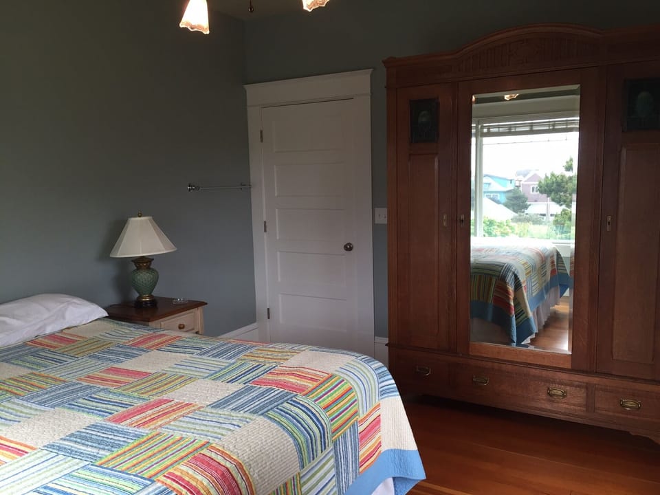 Main floor bedroom (king bed) with 1910 armoire.