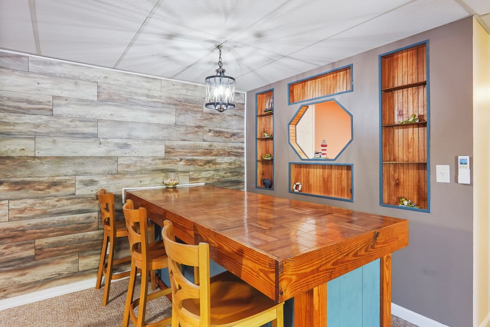 bar seating behind pool table