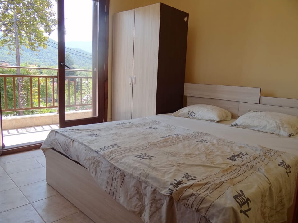 The bedroom with queen size bed and a balcony with stunning view