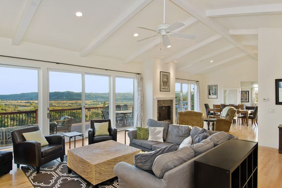Great Room with living area, fireplace, dining area and more views!