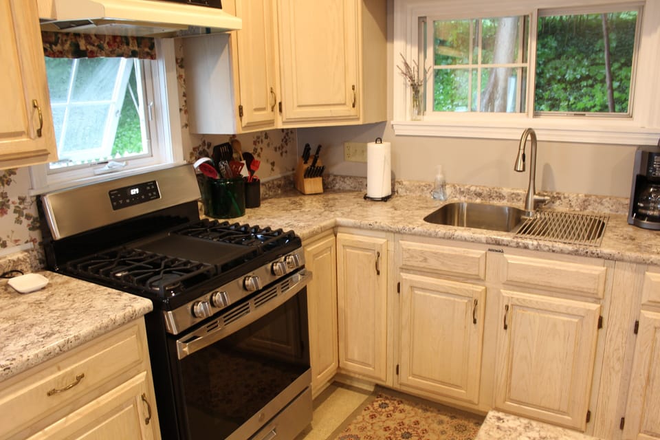 Updated kitchen with new countertops and stove with griddle.